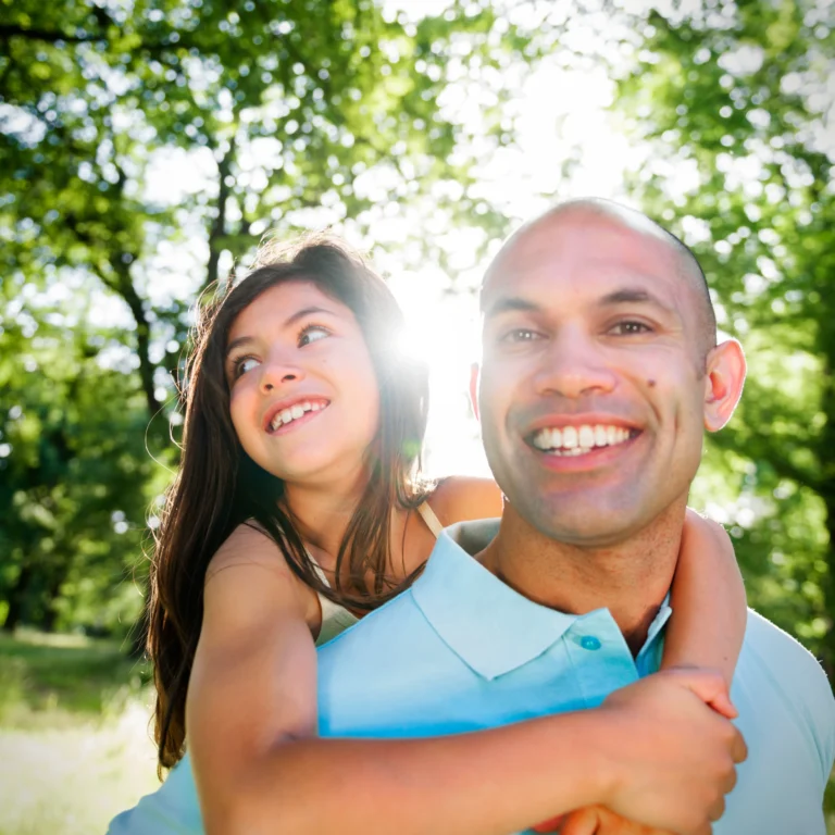 dad and daughter age 10 in park smiling . - therachange.co.uk